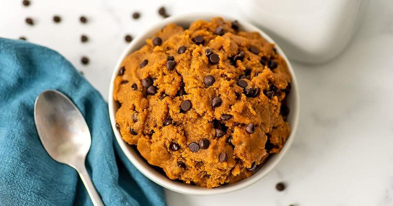 Protein cookie dough in a large white bowl with a spoon.