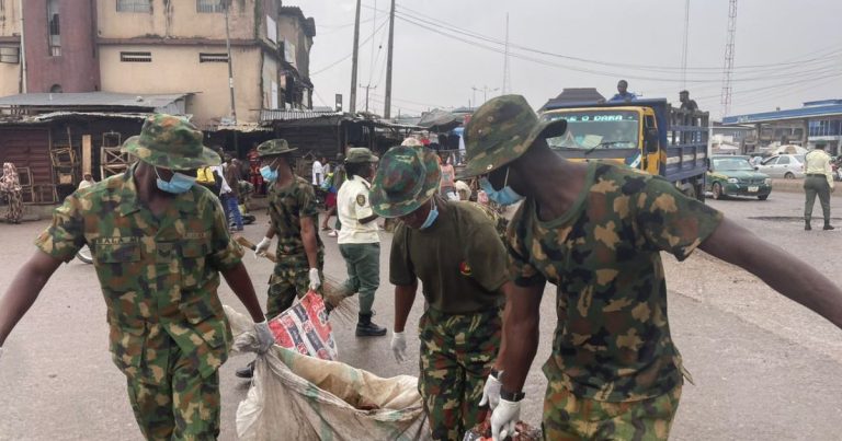 Soldiers clean Ogun market, clear drainage