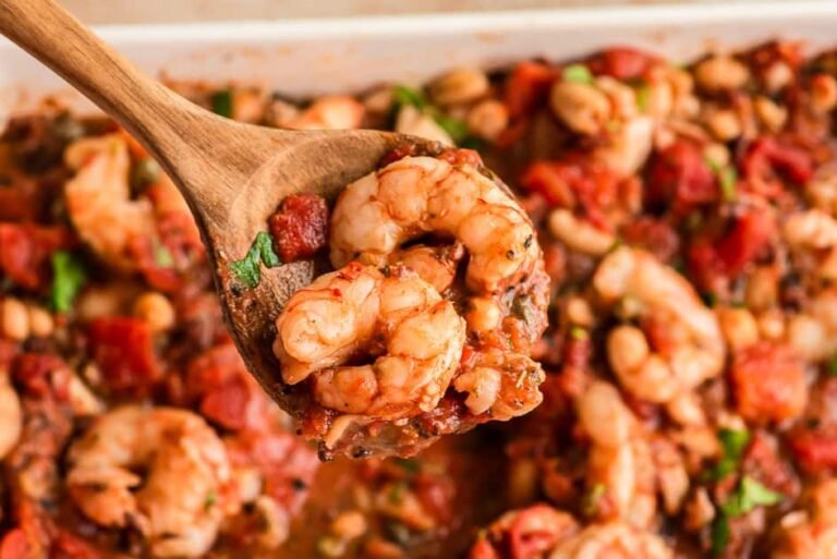 Large spoon filled with Mediterranean shrimip.