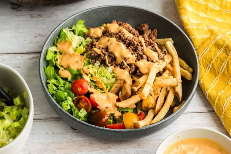 Burger bowl with special sauce drizzled over top.