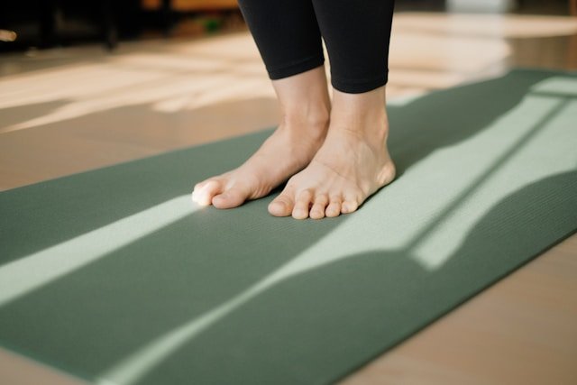 How Do You Stay Active With Chronic Back Pain? A person gently stretching at home